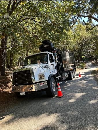 A white truck is parked on the side of a road.