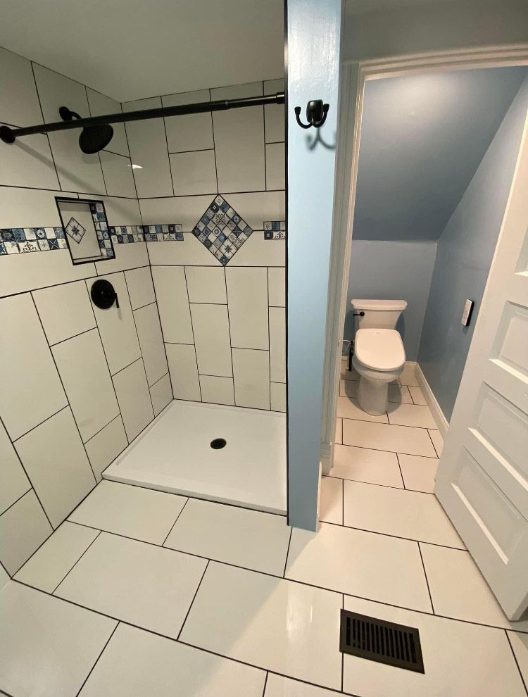 A bathroom with a walk in shower and a toilet