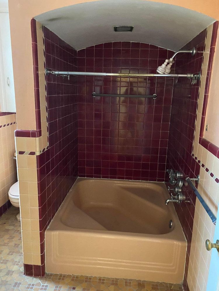 A bathroom with a bathtub and a shower.