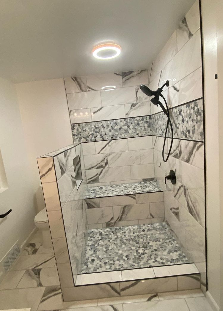 A bathroom with a walk in shower and a toilet.