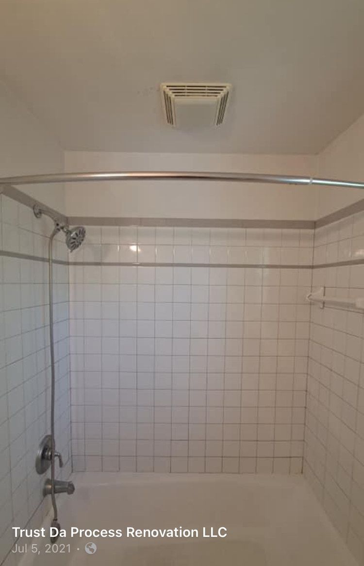 A bathroom with a bathtub , shower , and ceiling fan.