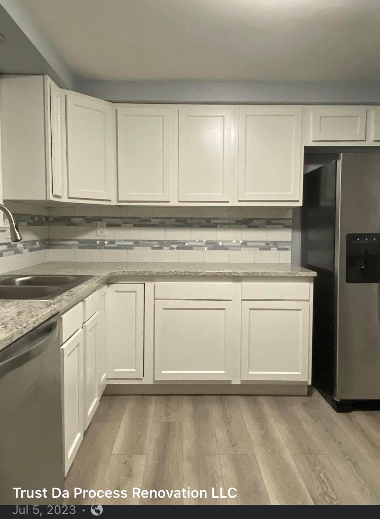 A kitchen with white cabinets and stainless steel appliances.