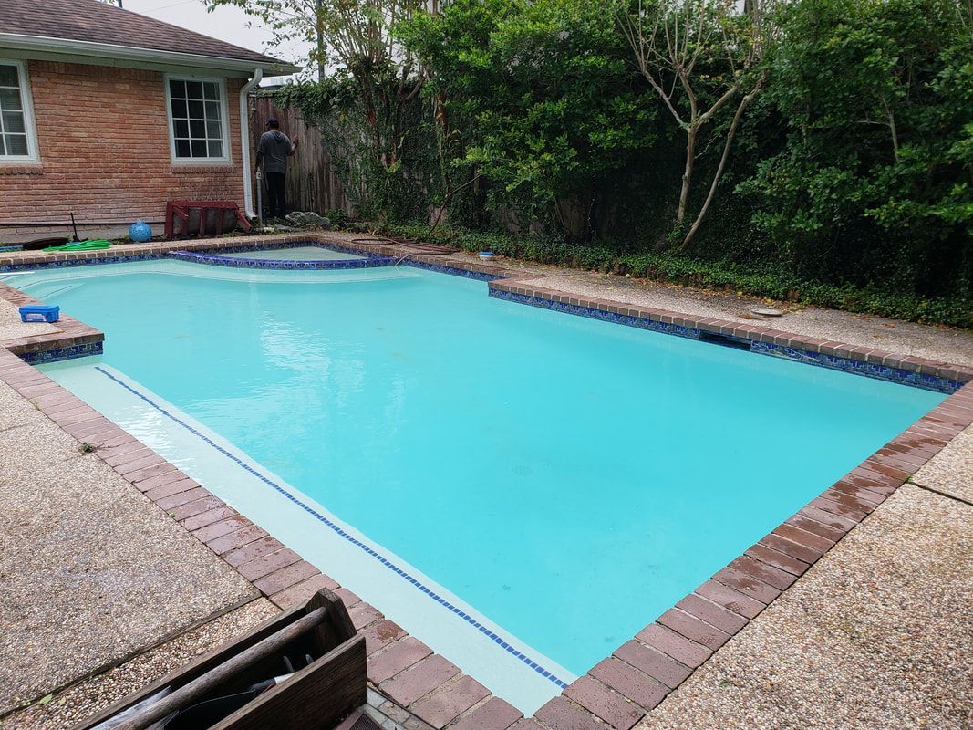 A large swimming pool in the backyard of a house.