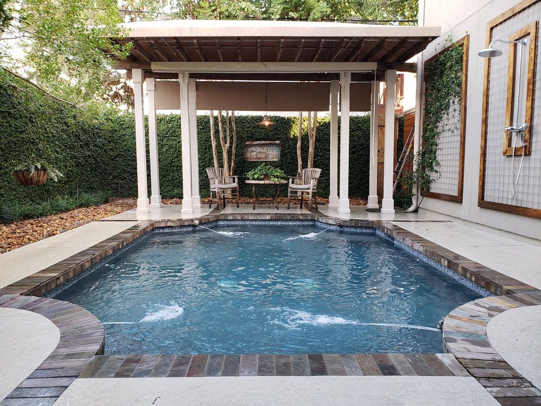 A large swimming pool with a pergola in the backyard.