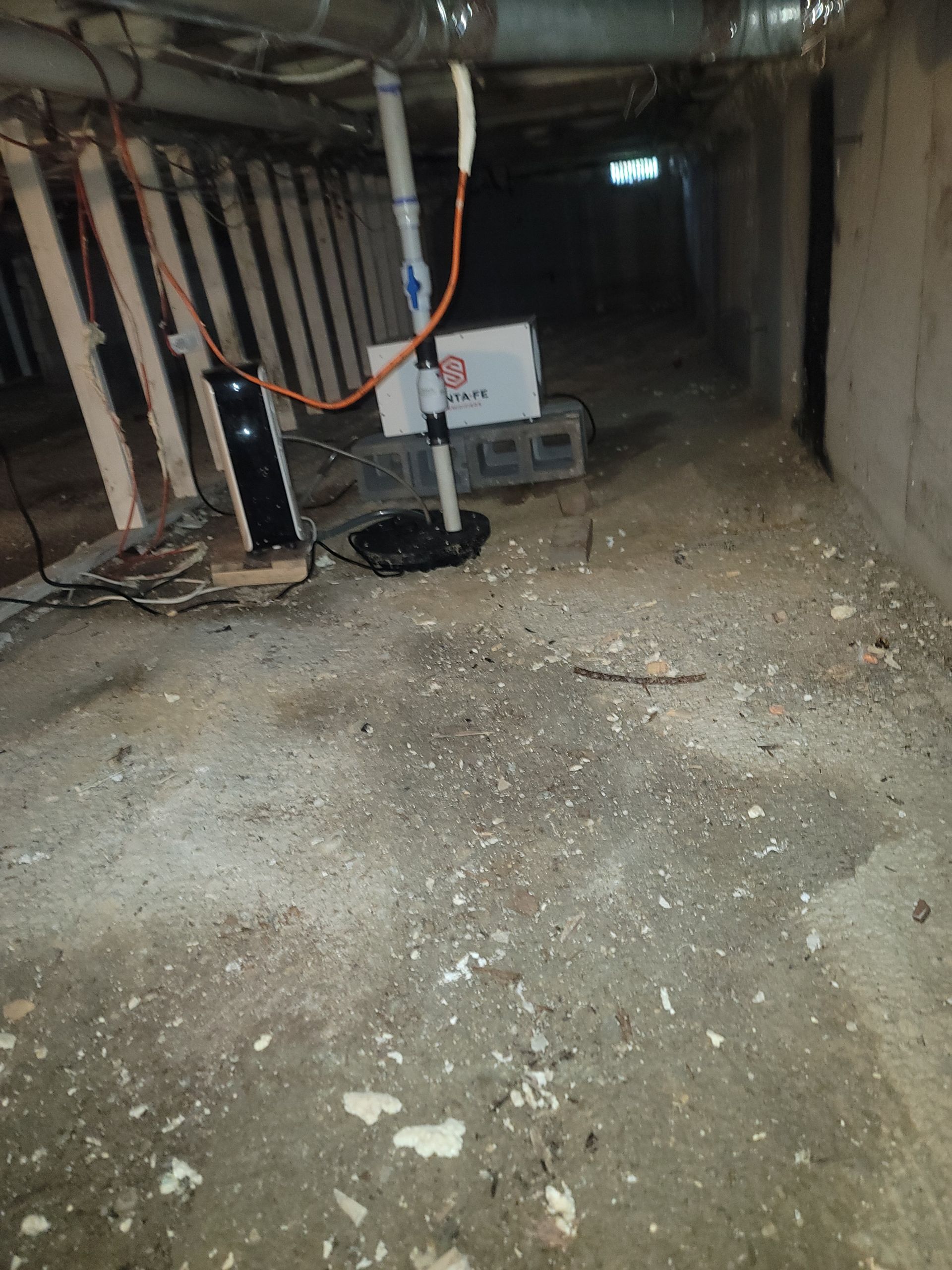 A dirty basement with a box on the floor.