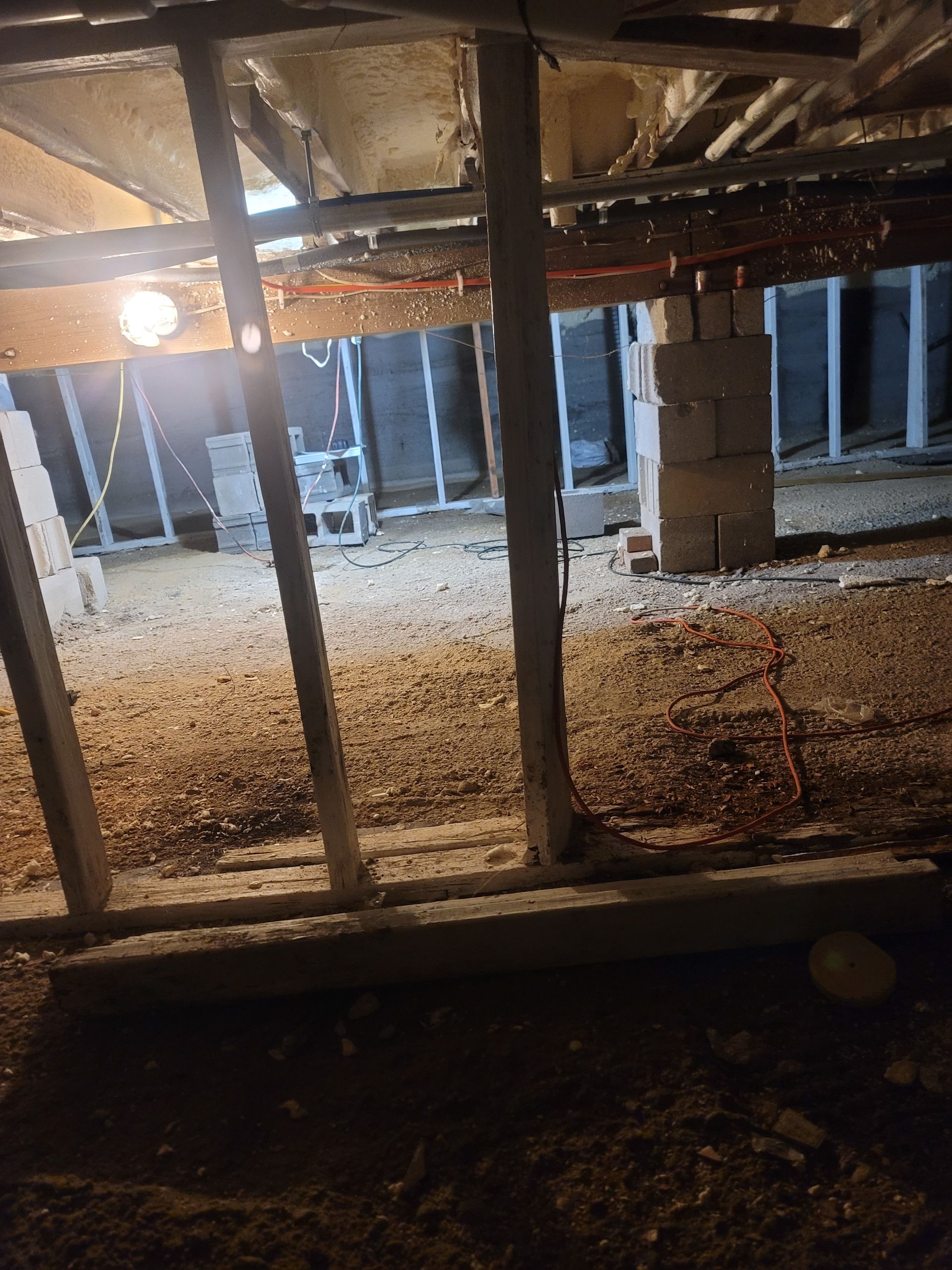 A basement with a lot of wood and a light on the ceiling.