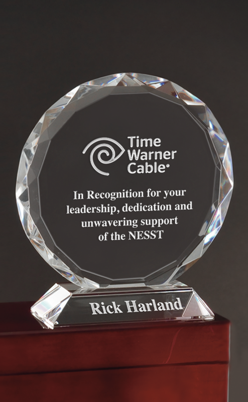 A circular crystal award on a stand, engraved with the Time Warner Cable logo, an appreciation message, and Rick Harland.
