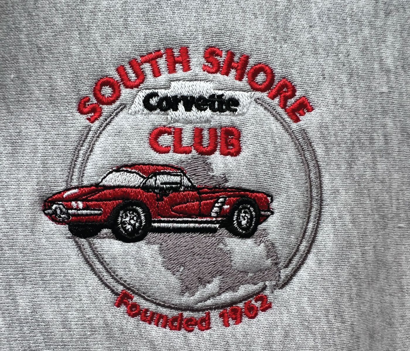 Embroidered logo on gray fabric:
