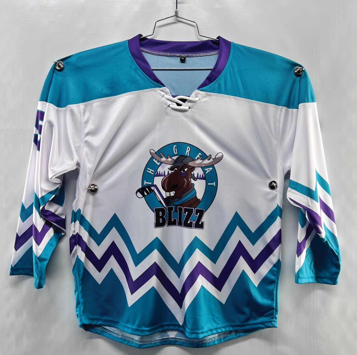 Custom sublimated hockey jersey with white, blue, and purple design; featuring