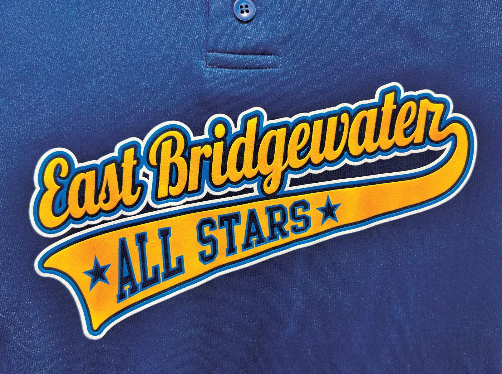 Logo for East Bridgewater All Stars in yellow script and blue block text on a blue fabric background.