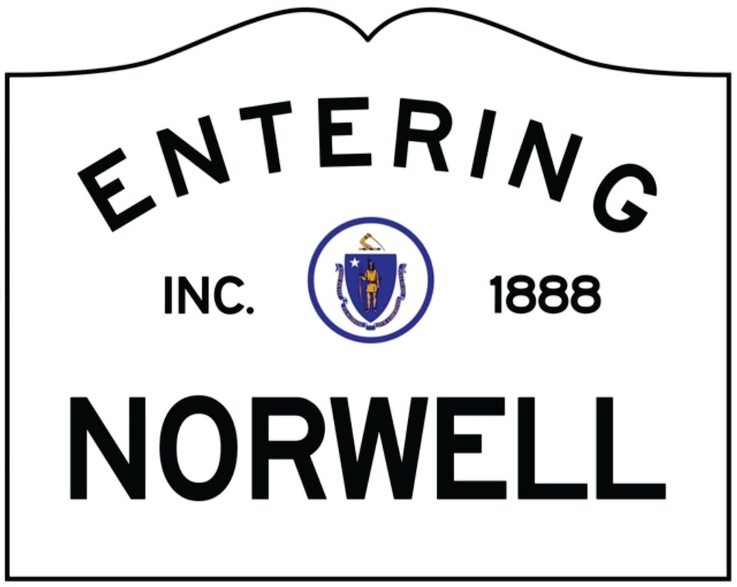 A white town sign reading