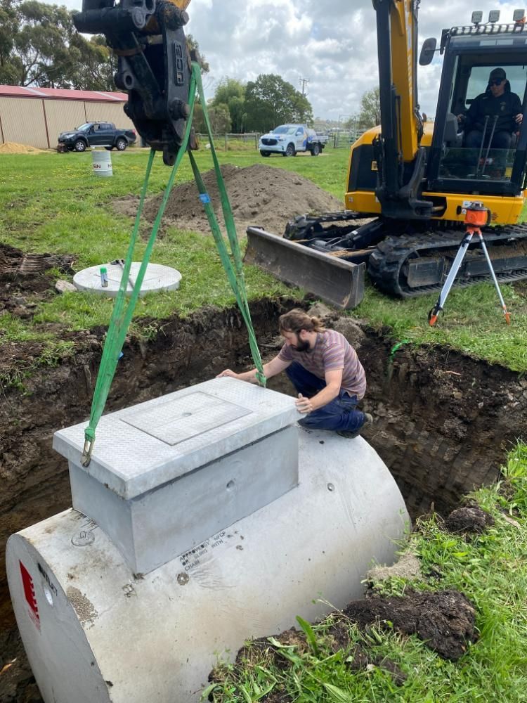 Large Concrete Tank Is Being Installed With Excavator Inside the Trench In Ground — ASAP Local Plumbing in Warrnambool, VIC