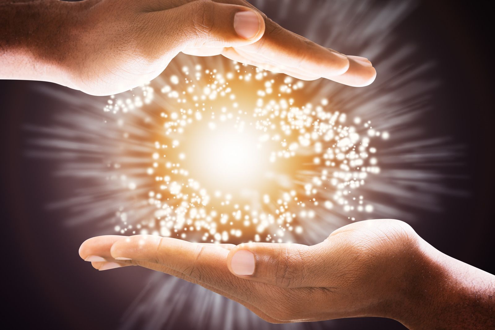 A person is holding a light in their hands.