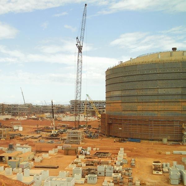 A large building under construction with a crane in the background