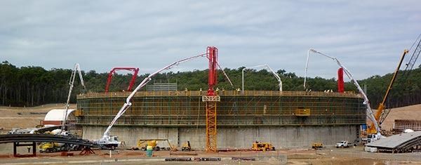 A large concrete structure is being built on a construction site.