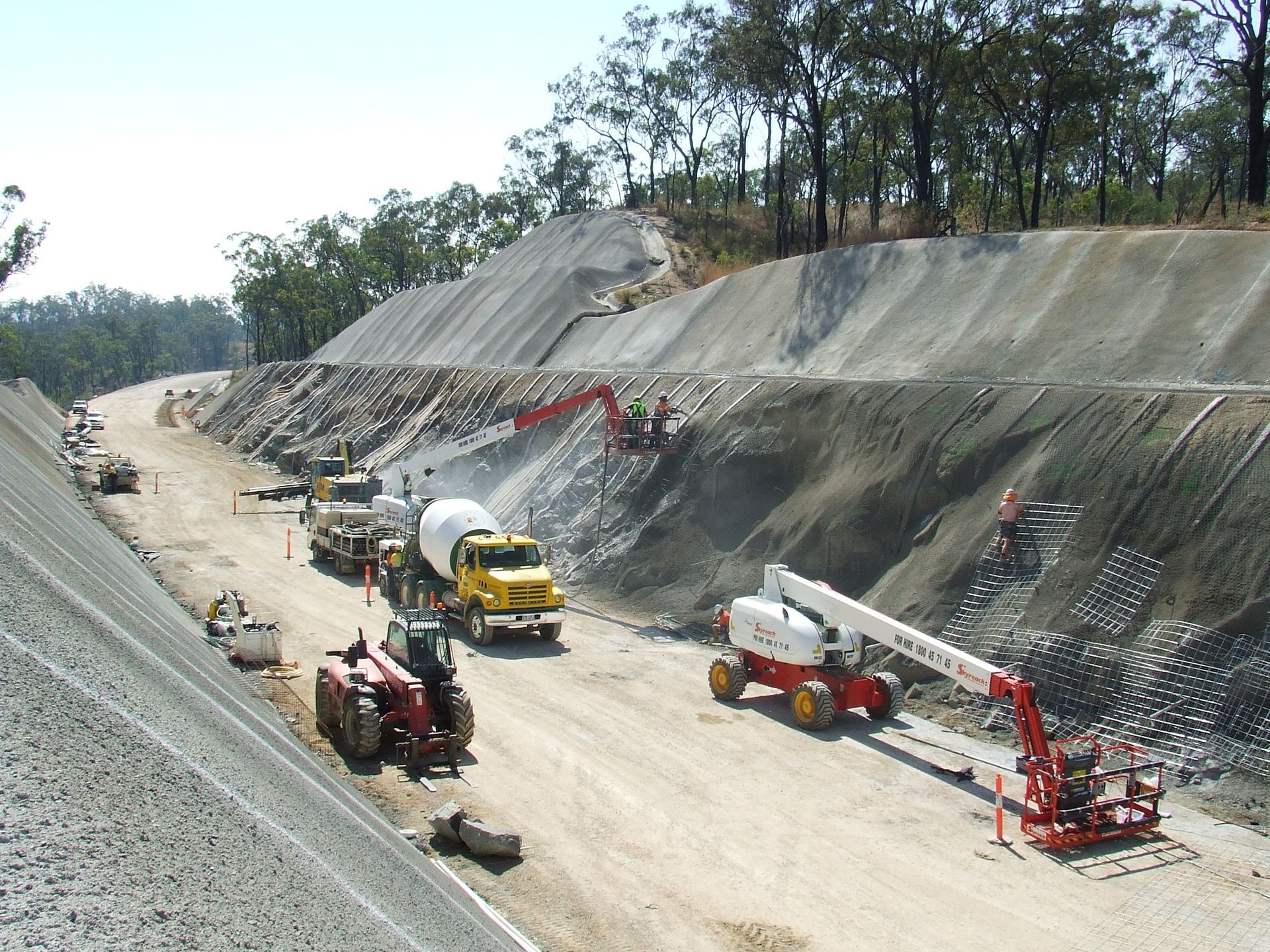 A construction site with a lot of trucks and tractors