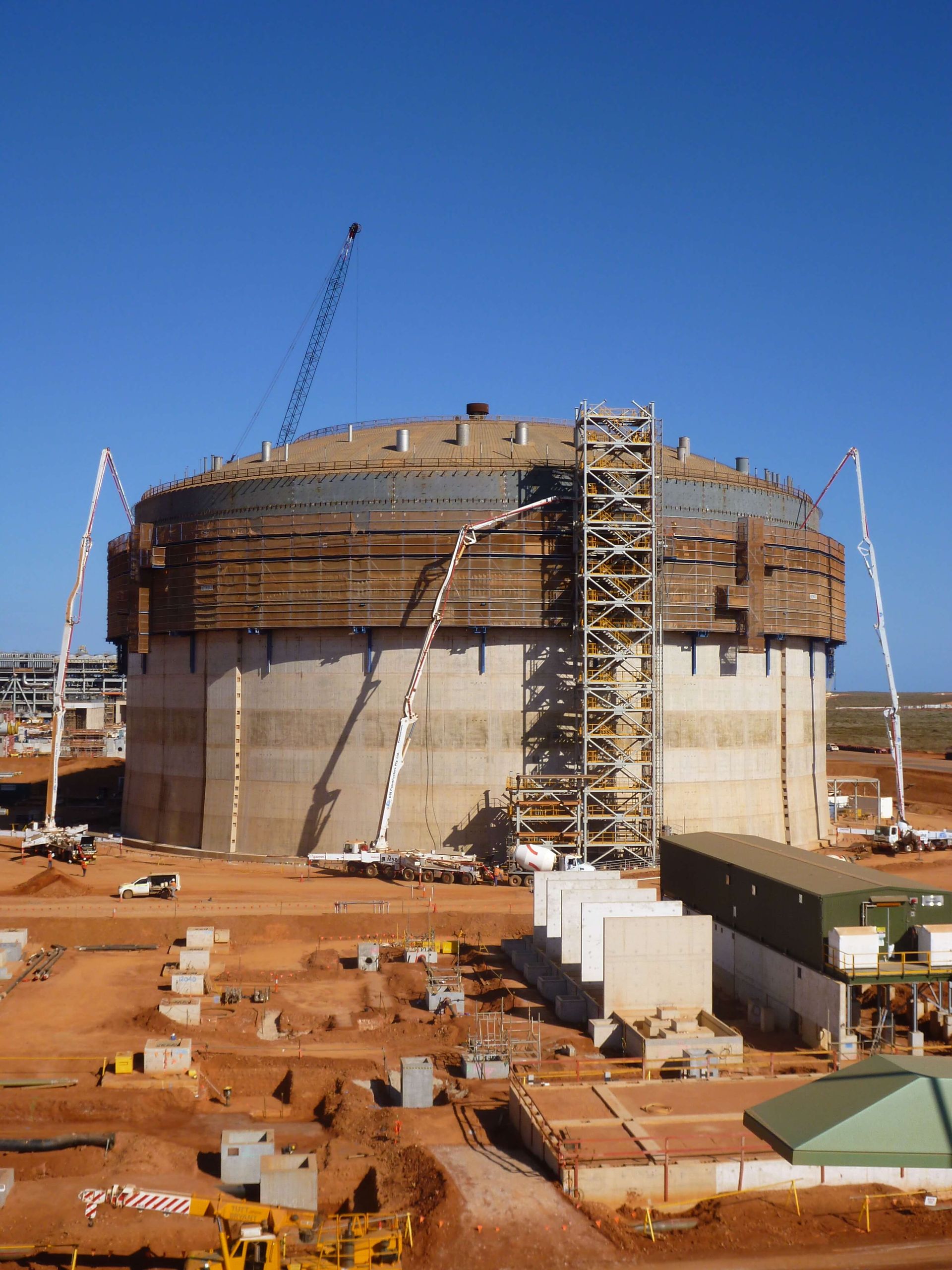 A large building under construction with a blue sky in the background