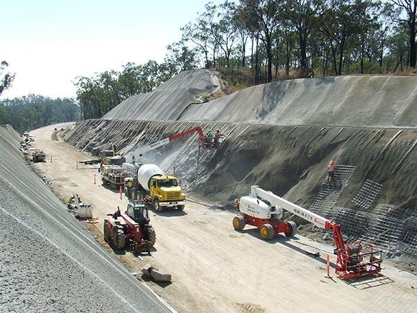 A construction site with a lot of trucks and tractors