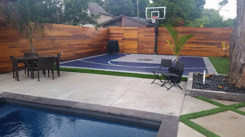 “Modern backyard basketball court with a hoop, patio space, and privacy fence after a court builder service in Henderson, NV”