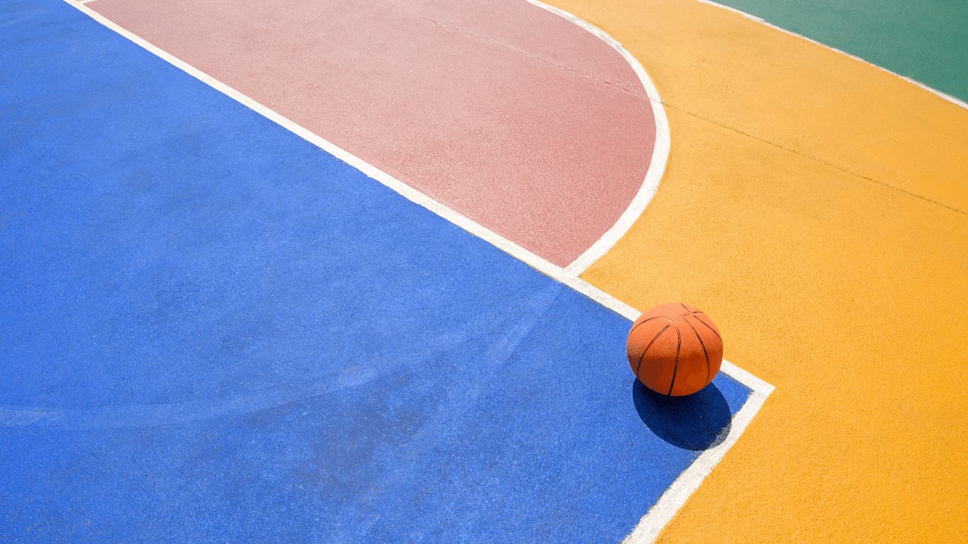 “Basketball resting near bright white lines on a colorful outdoor court surface during a court builder service in Henderson, NV”