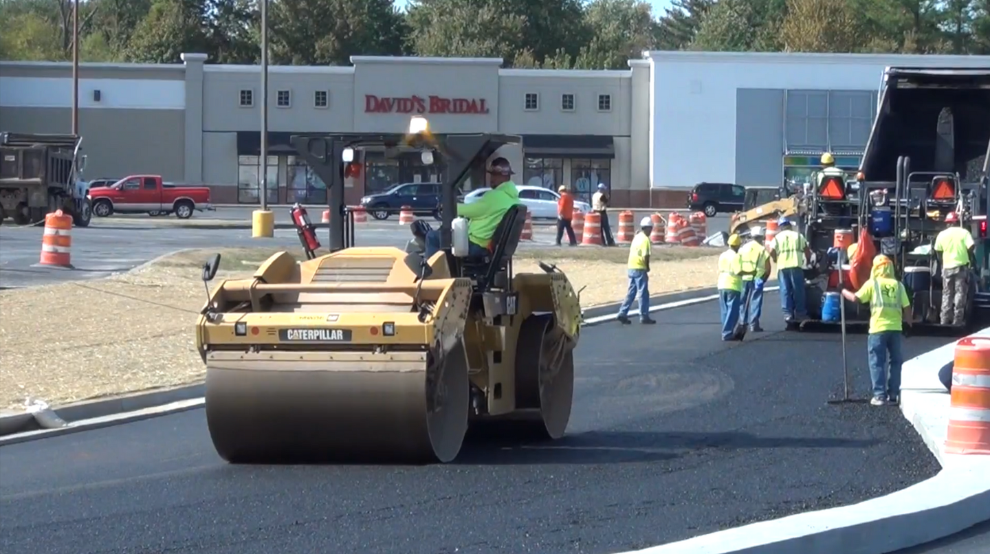 Our asphalt crew paving a parking lot