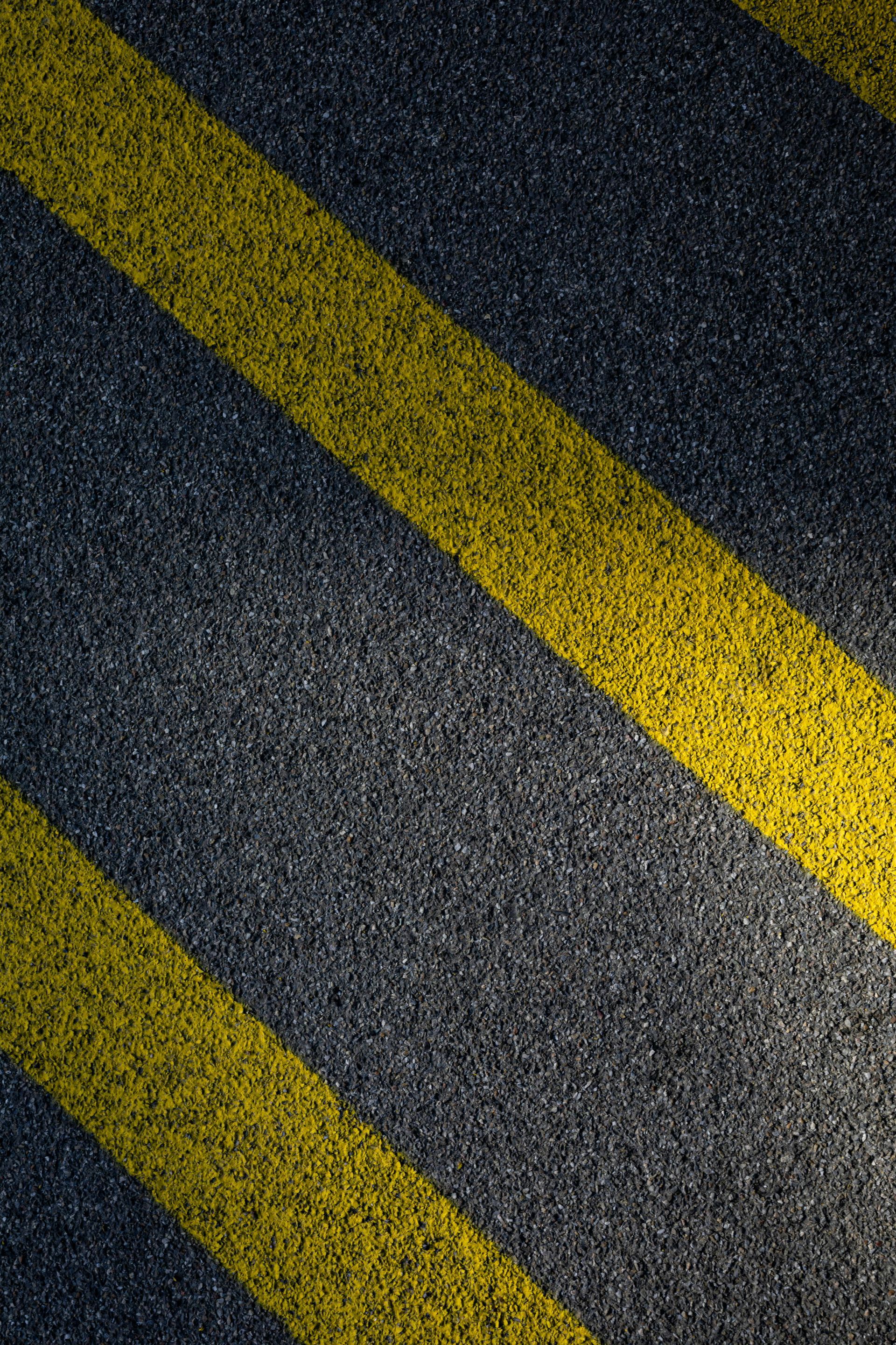 Yellow striping on an asphalt road