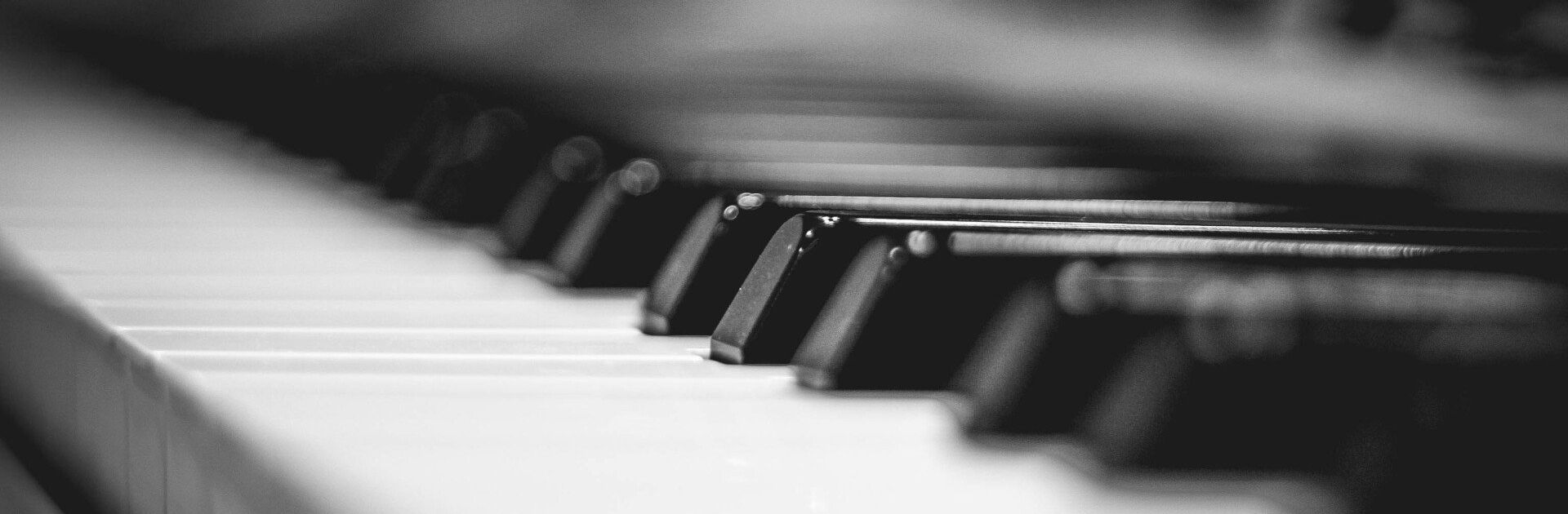 A black and white photo of a piano keyboard.