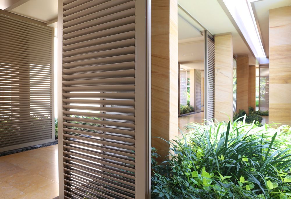 A Building With a Row of Shutters on the Side of It — Manning Blinds & Awnings in Forster, NSW