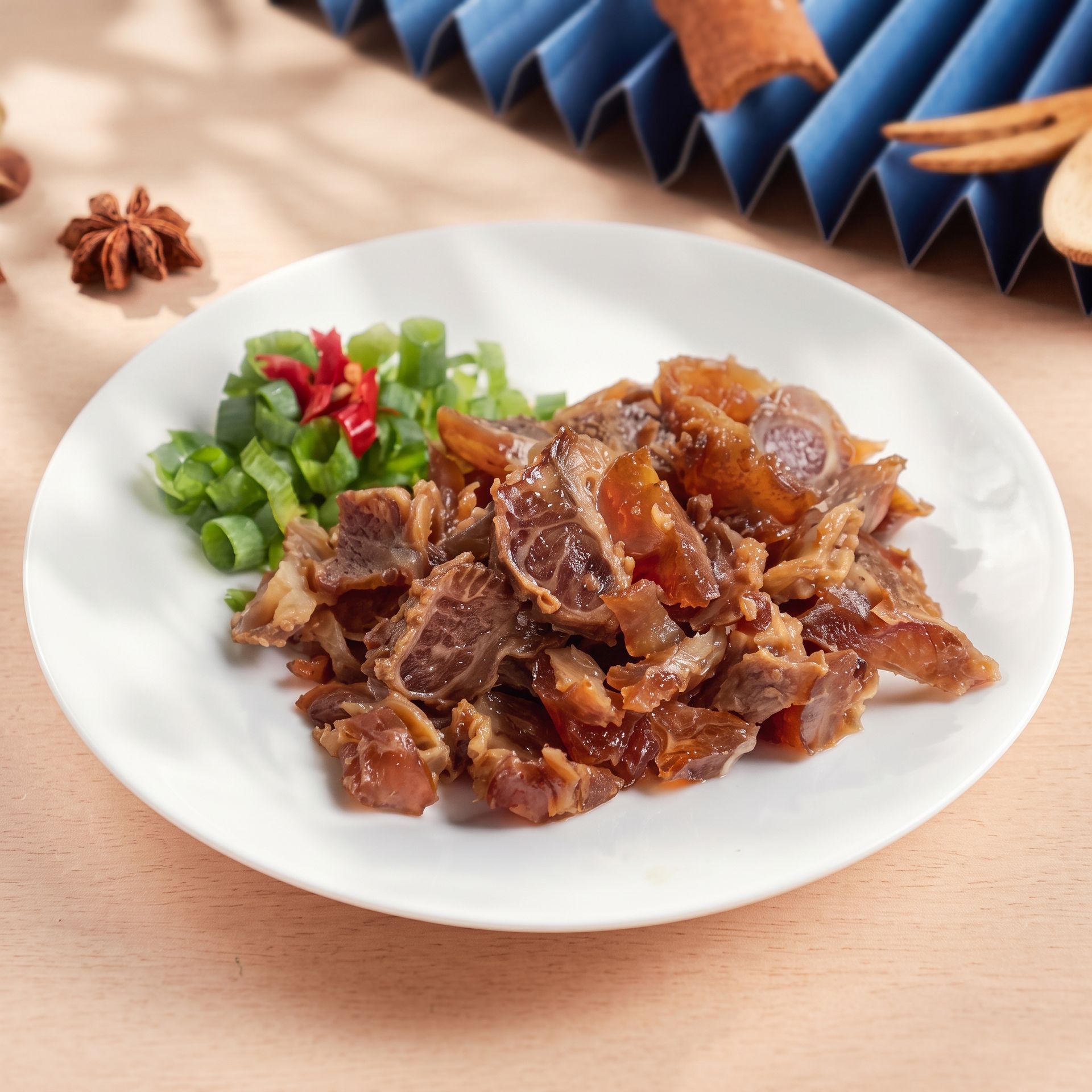 Plate of chopped meat with diced green peppers on a light wooden table