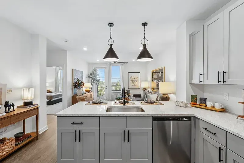 Modern kitchen with island and living room view.