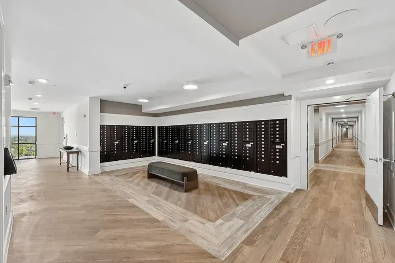Hallway with mailboxes and a bench