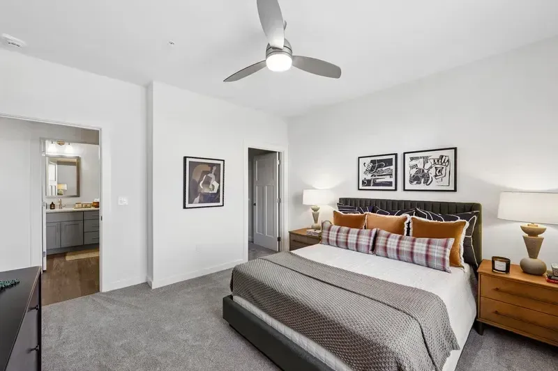 Cozy bedroom with a king-size bed, plush bedding, and a ceiling fan.