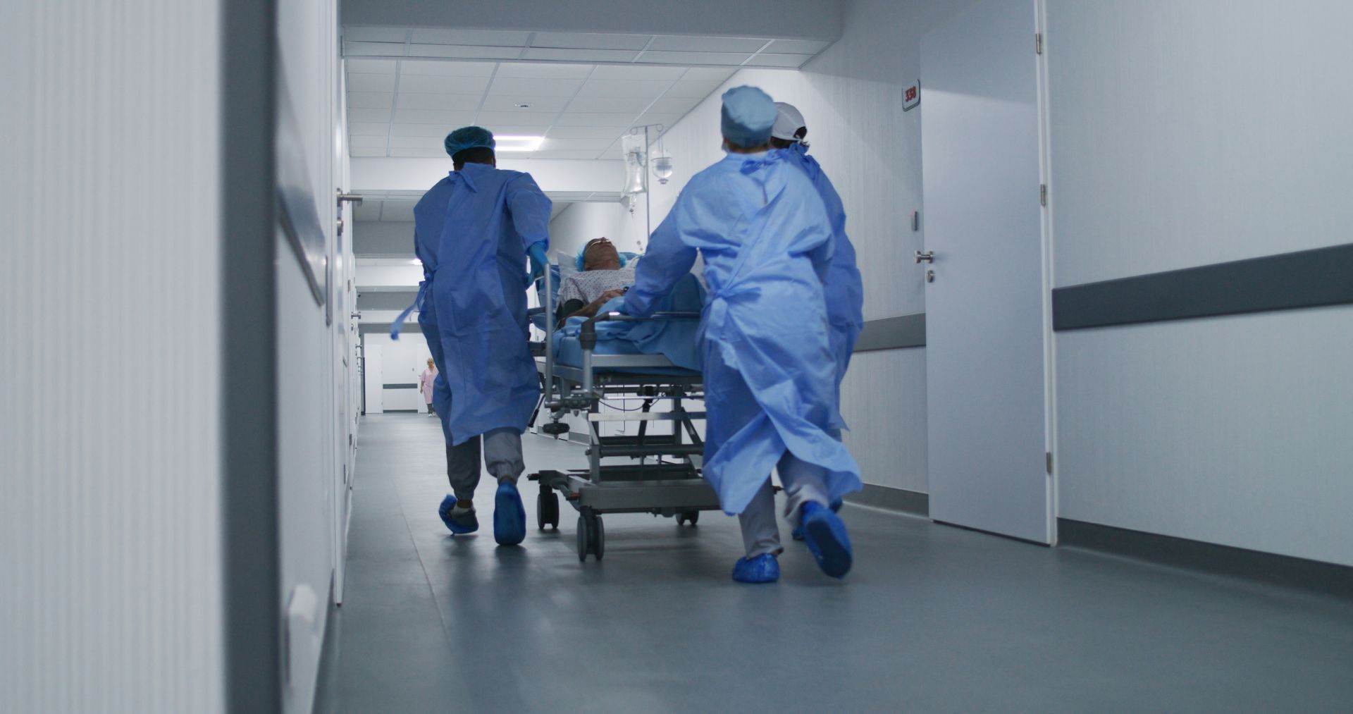 The medical team hurries the patient on the stretcher into the emergency room.