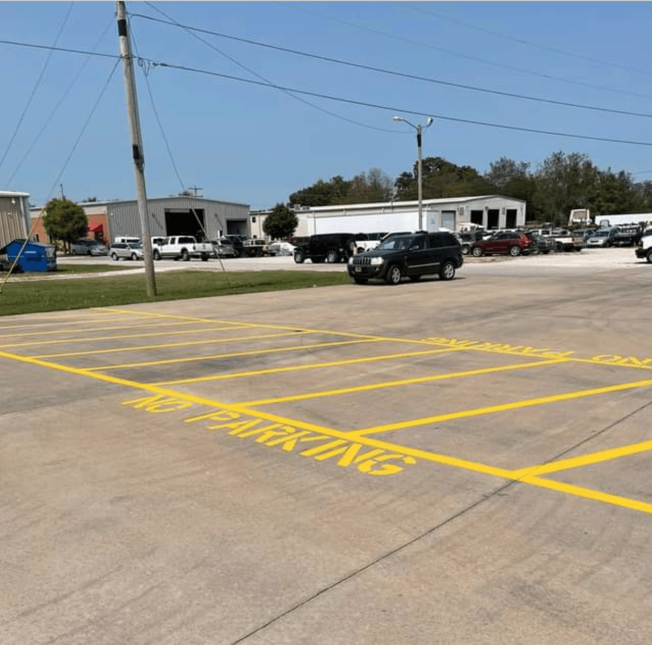 A parking lot with yellow lines that say no parking