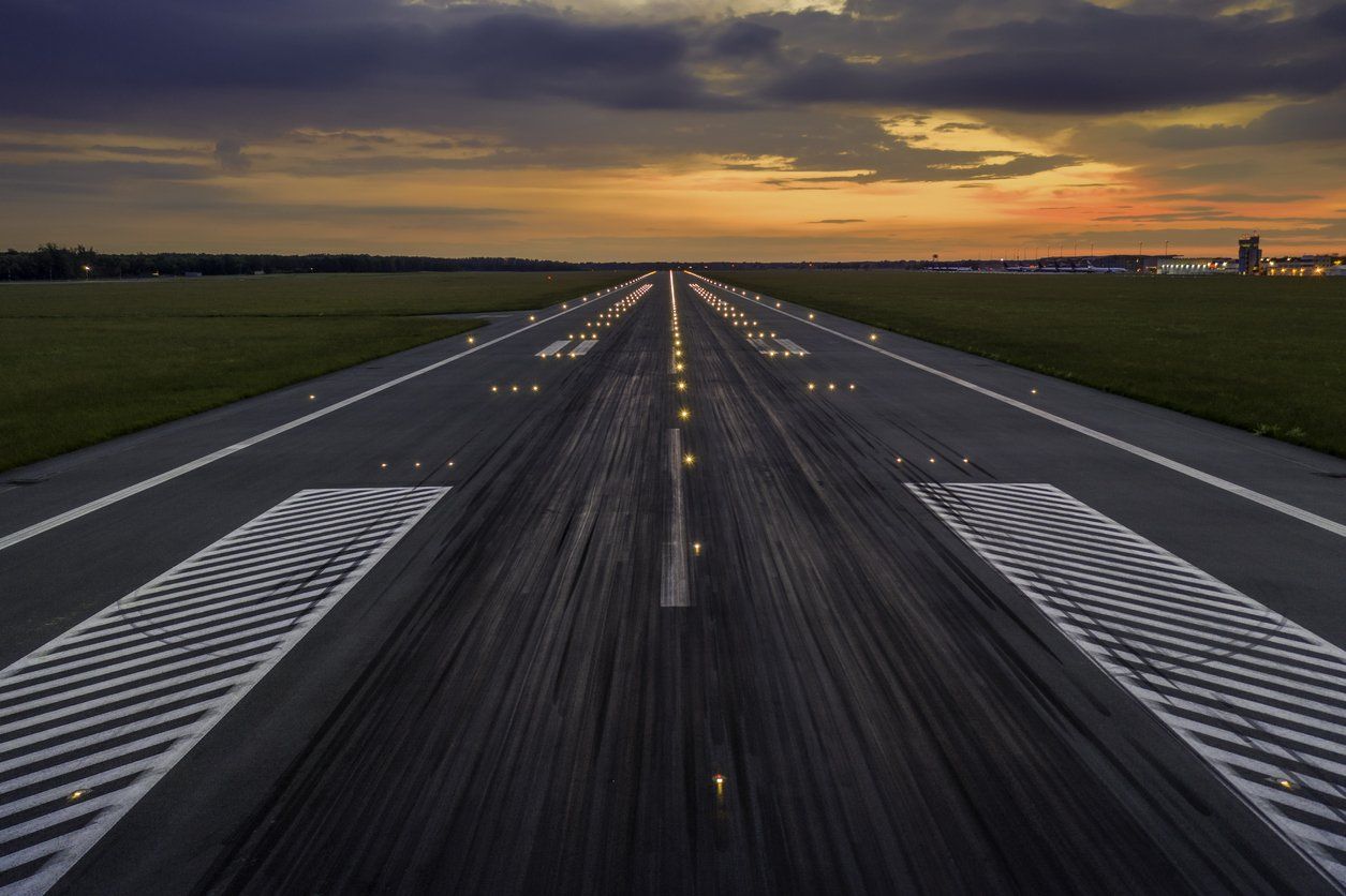 A runway with a sunset in the background