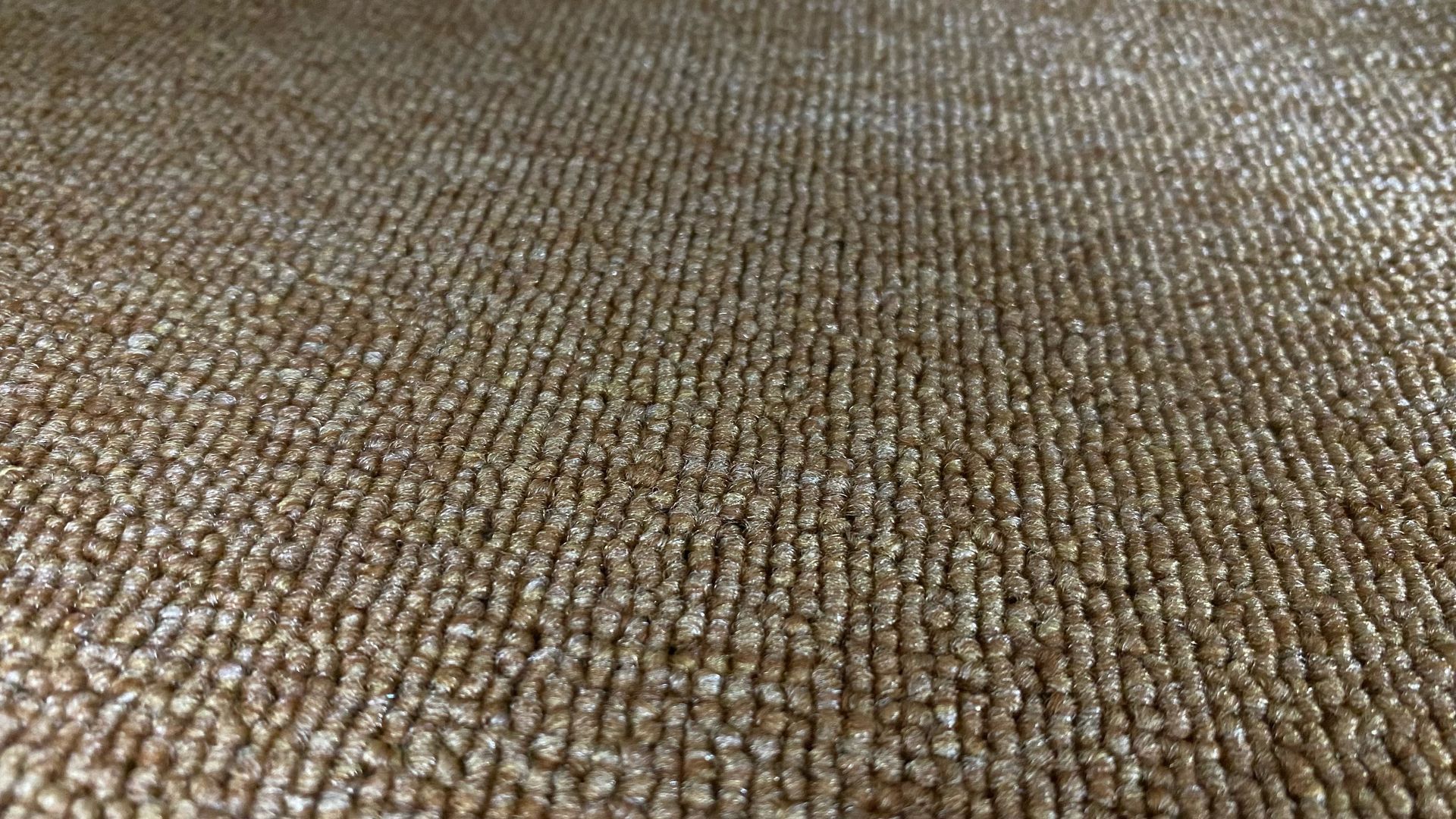 Close-up of a brown woven fabric or carpet texture