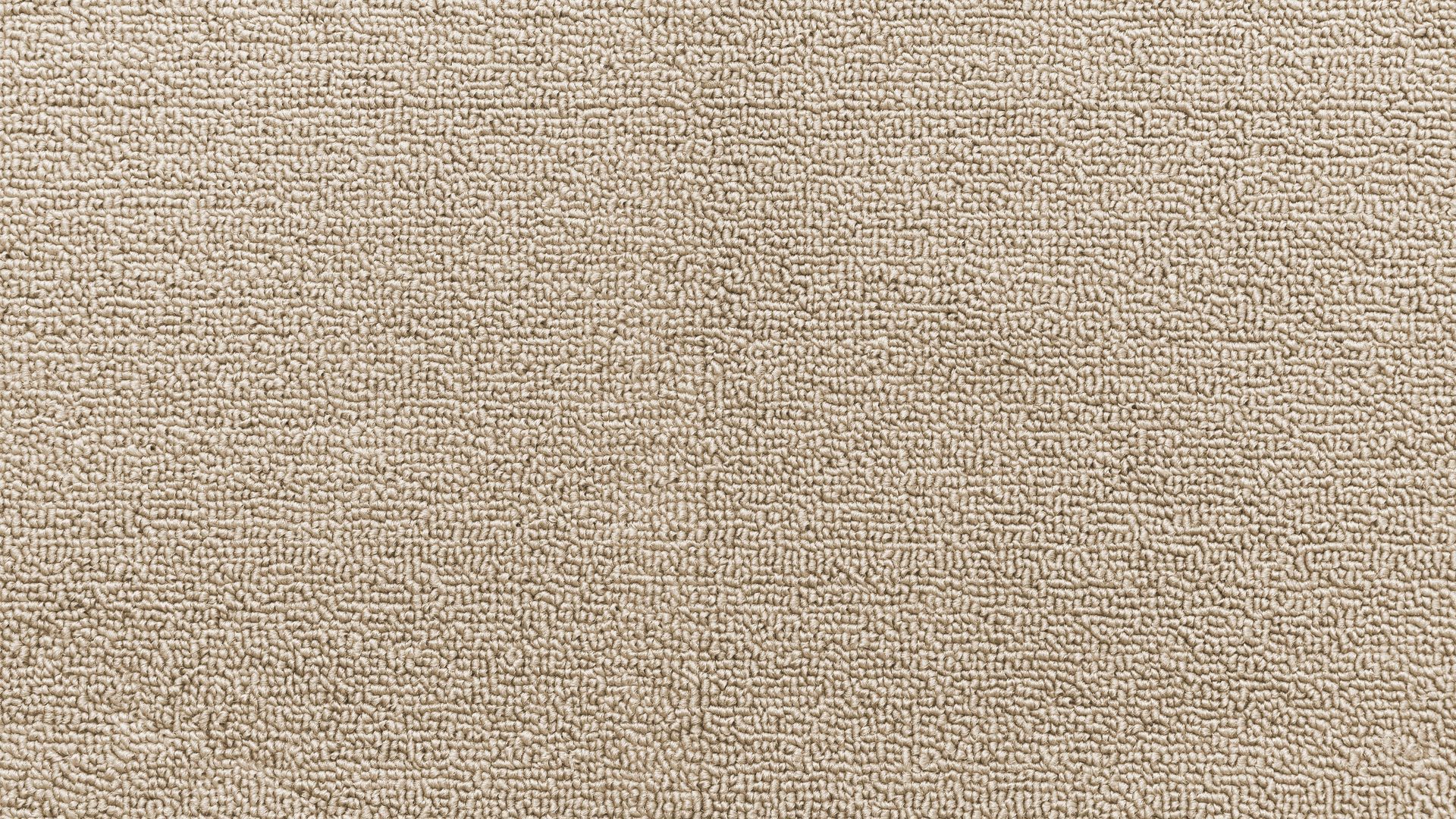 Close-up of a beige textured fabric or carpet surface
