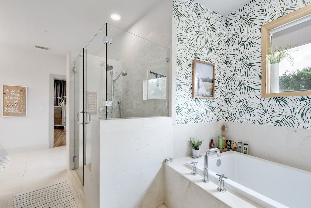 A bathroom with a bathtub , shower , and mirror.