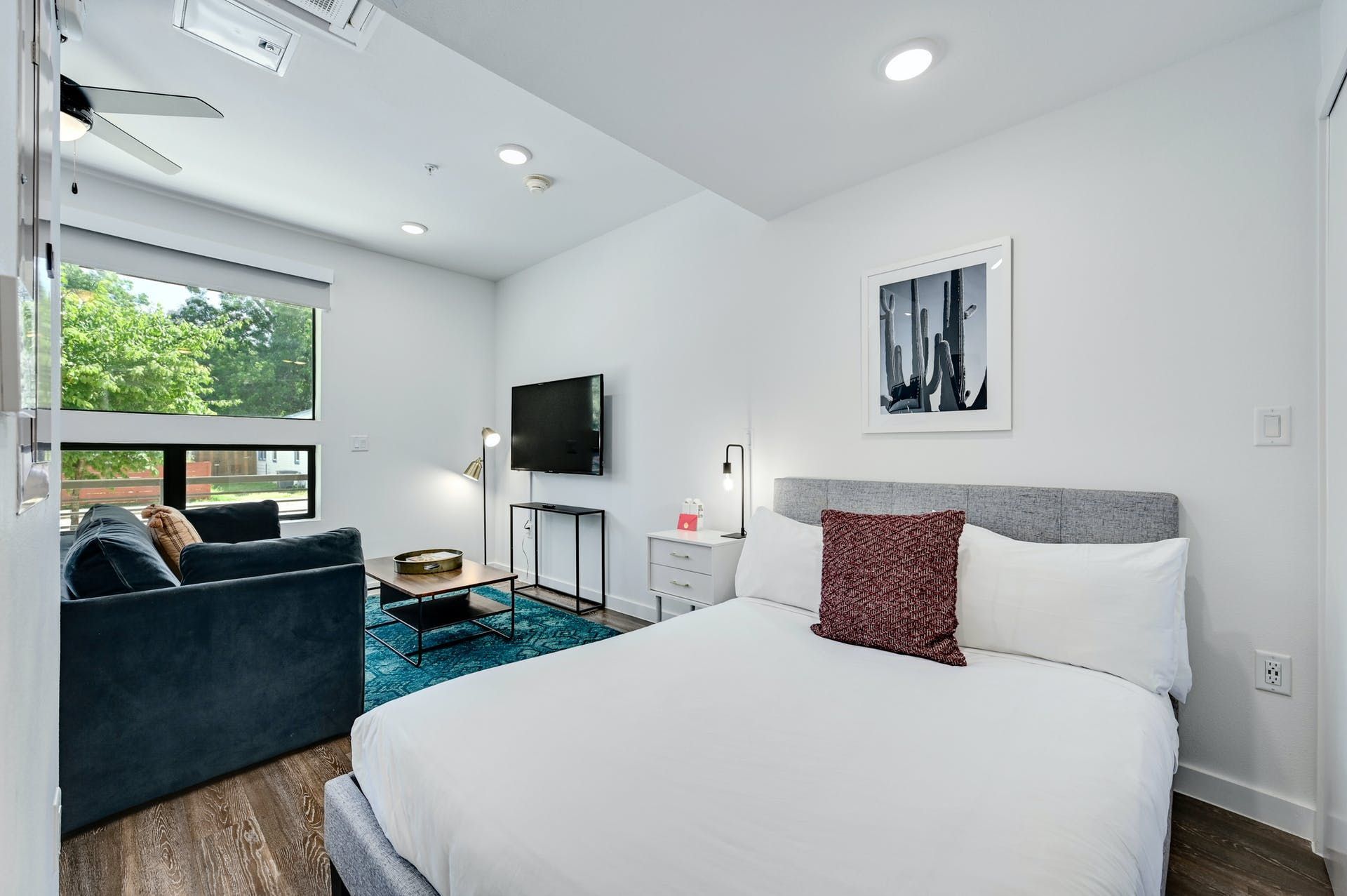 A bedroom with a king size bed , couch , and television.