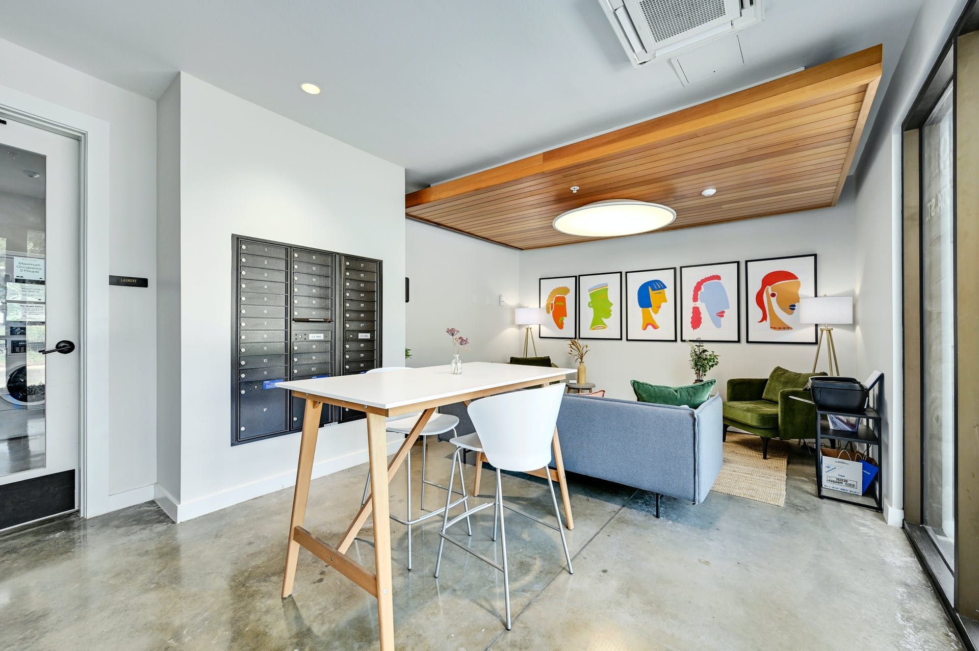 A living room with a table and chairs and a couch.