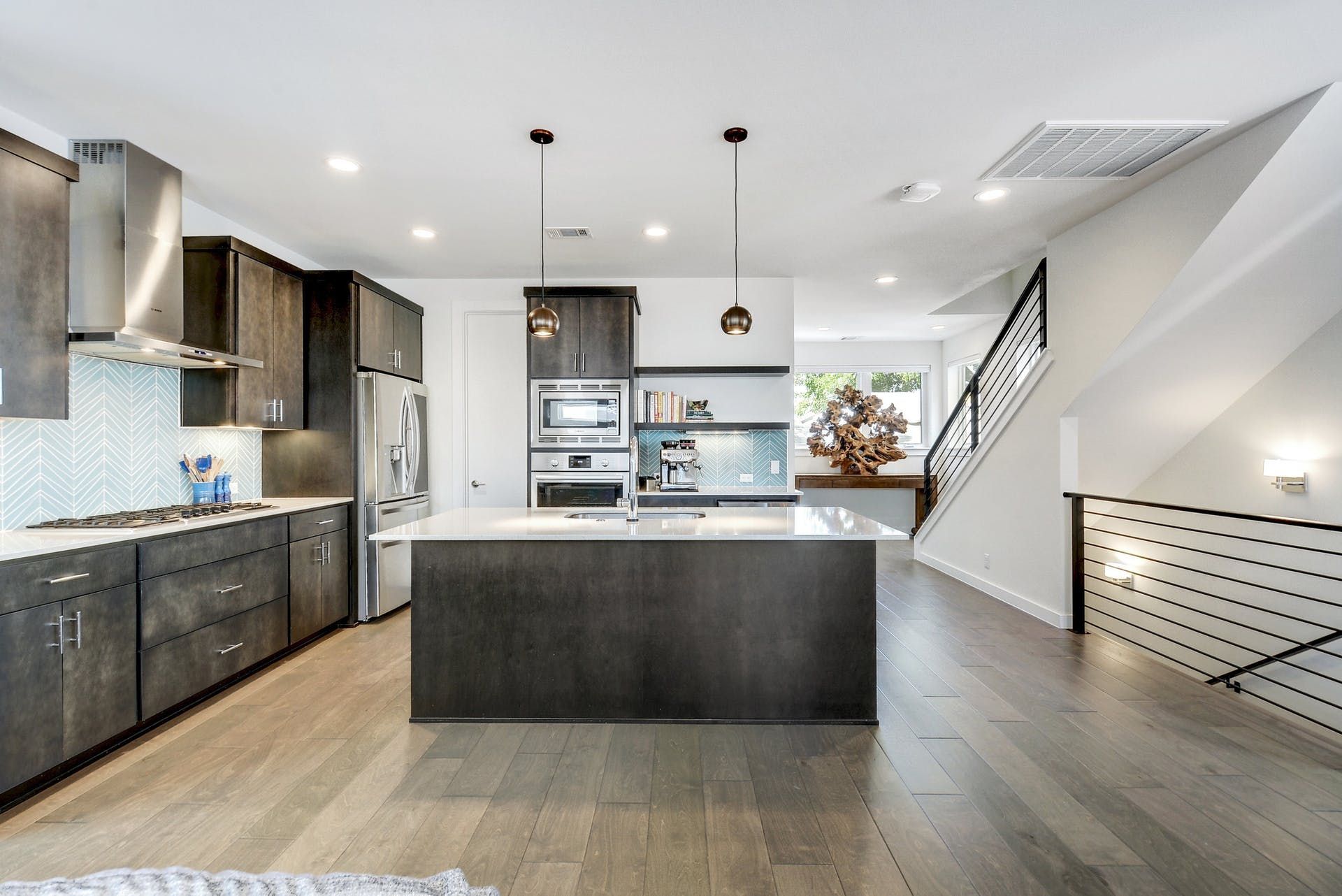 A kitchen with stainless steel appliances and a large island.
