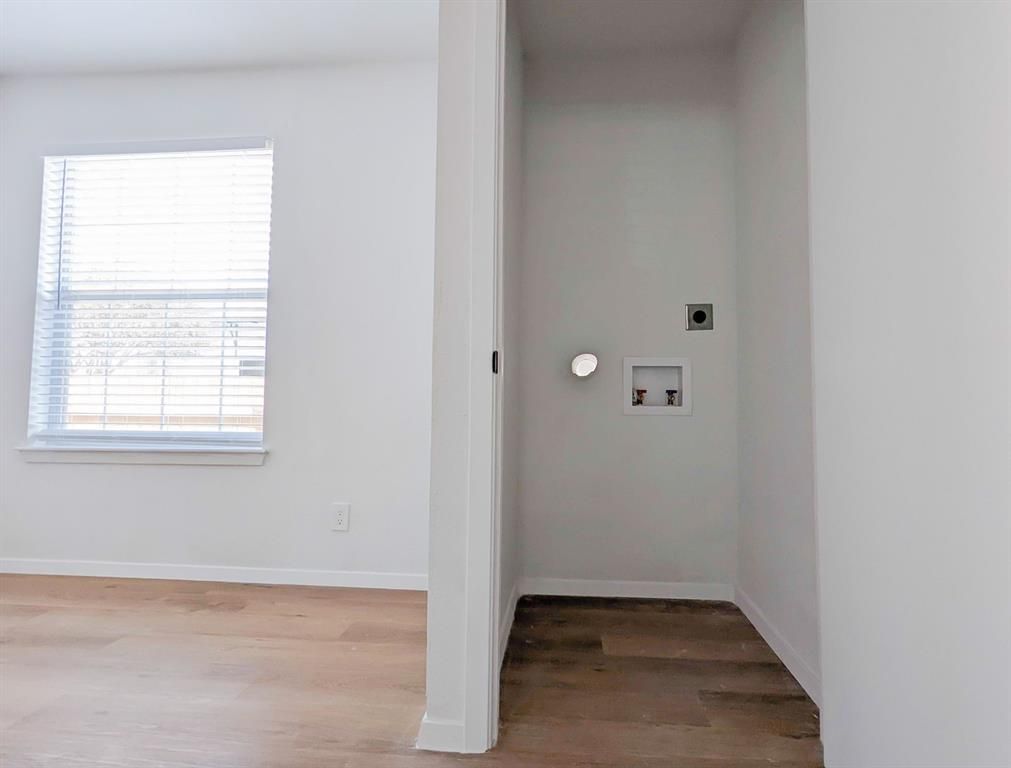 There is a laundry room in the middle of the room.