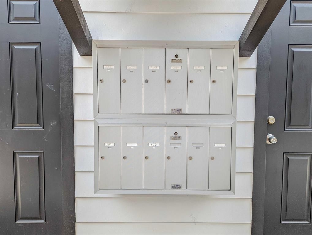 A row of mailboxes on the side of a building