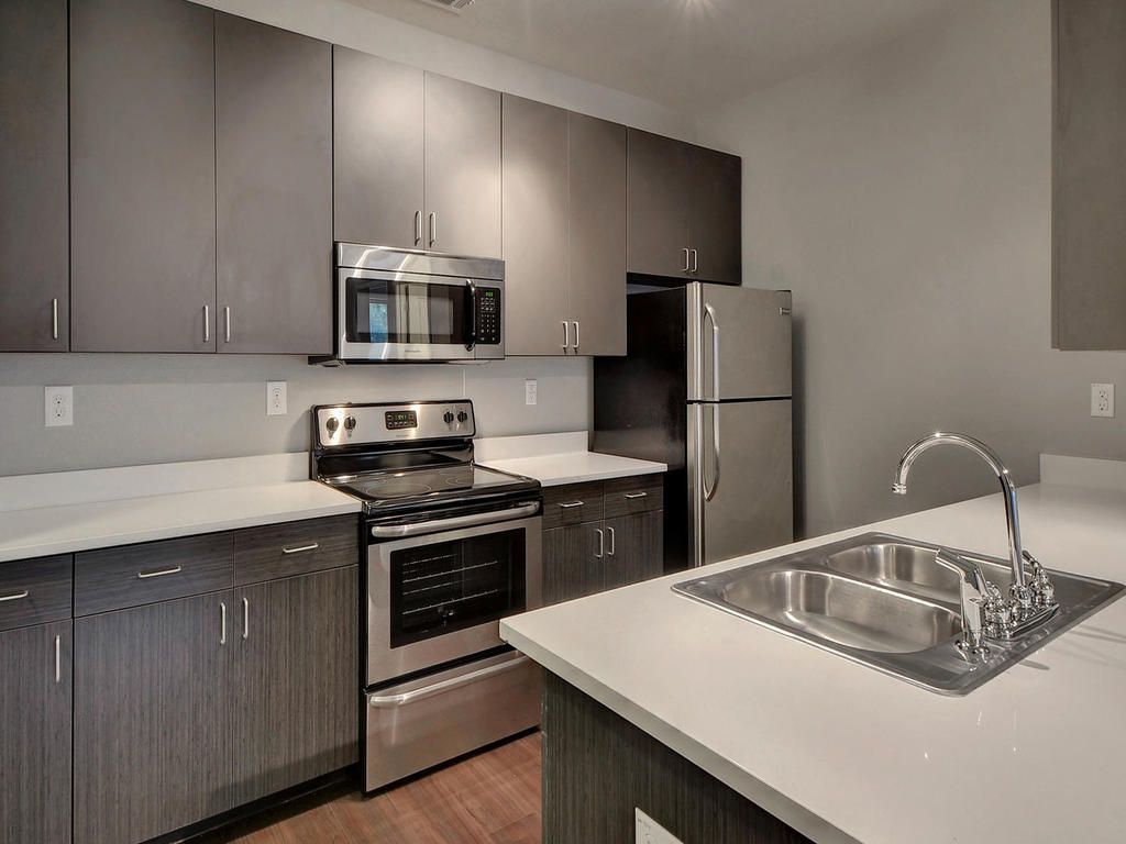 A kitchen with stainless steel appliances and a sink