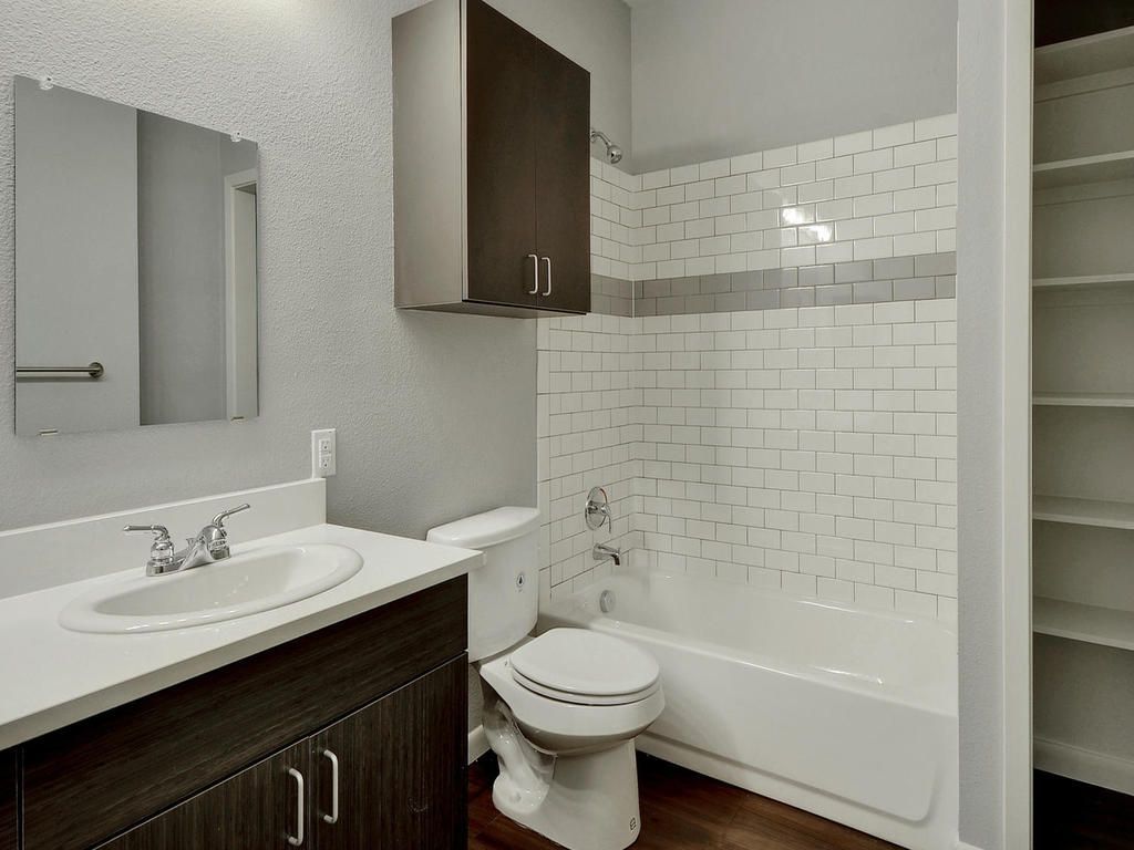 A bathroom with a toilet , sink and bathtub