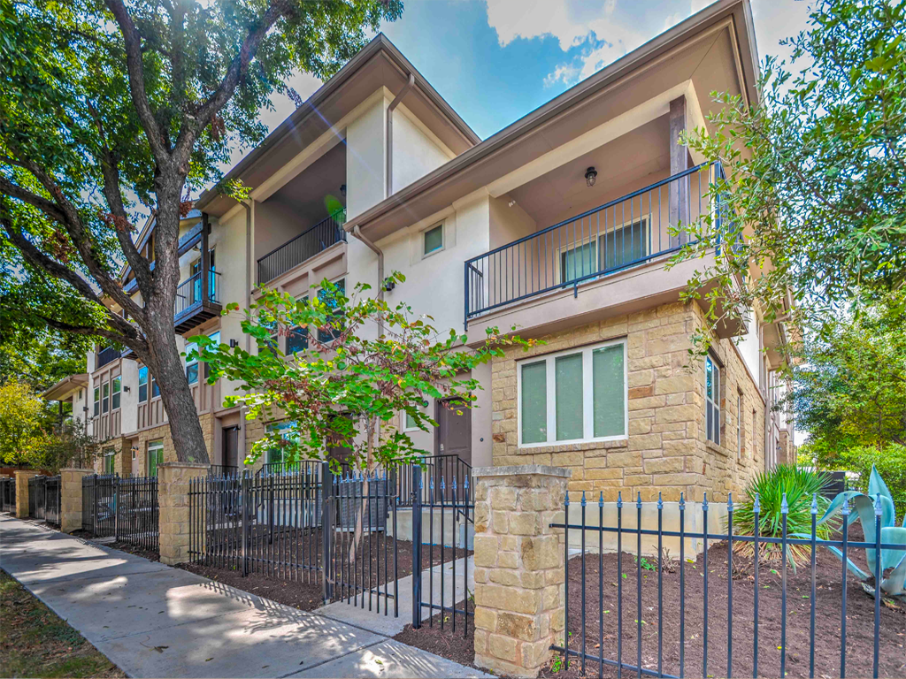 A large apartment building with a fence around it
