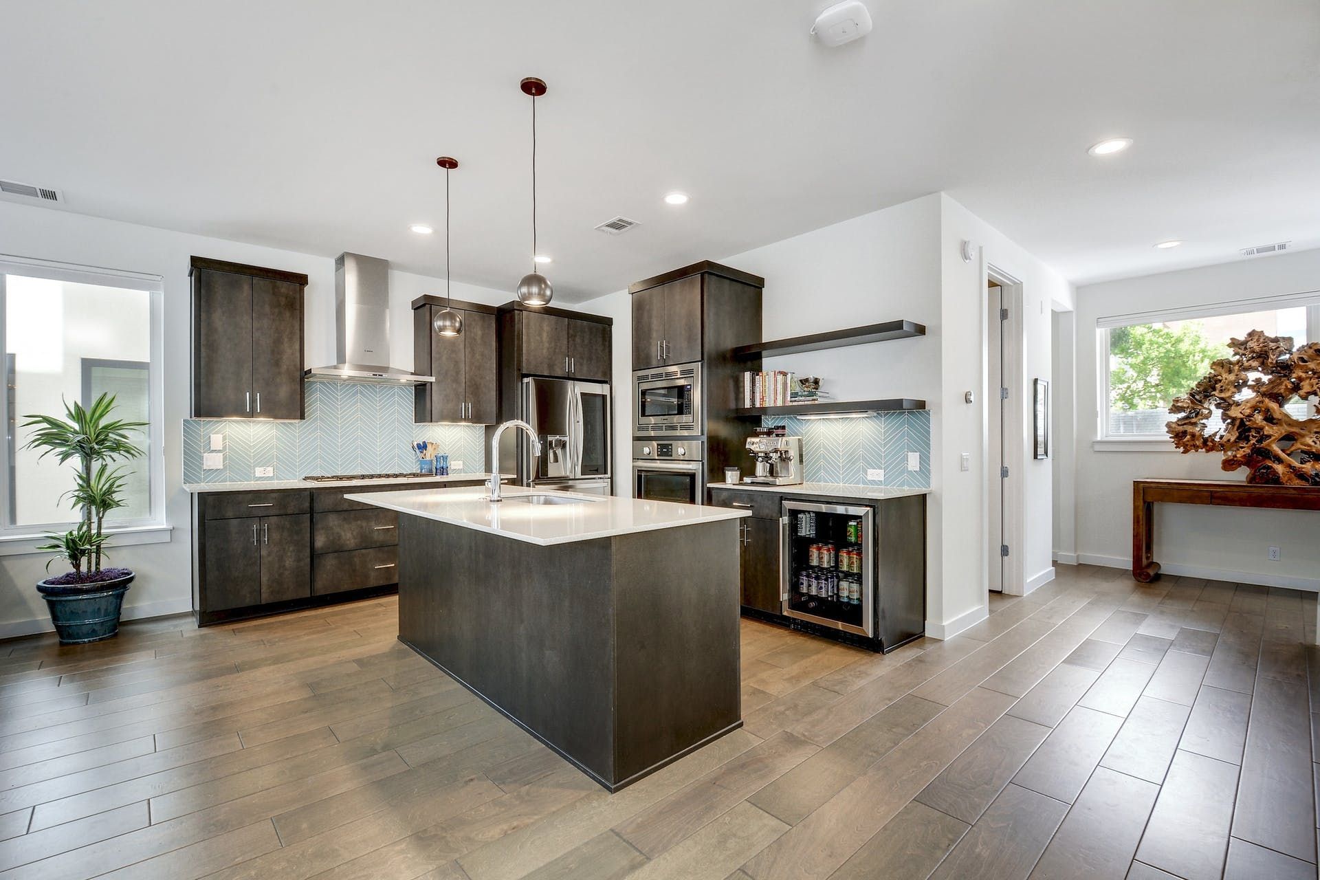 A kitchen with a large island and stainless steel appliances.