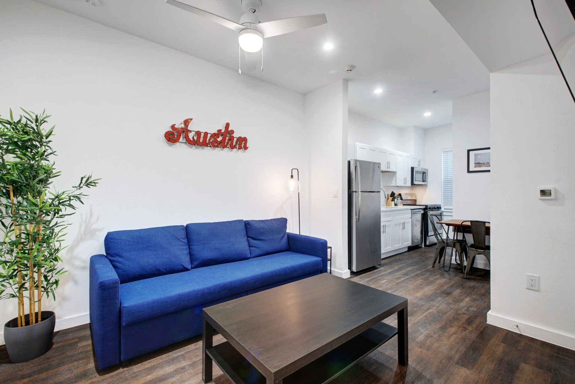 A living room with a blue couch and a coffee table.