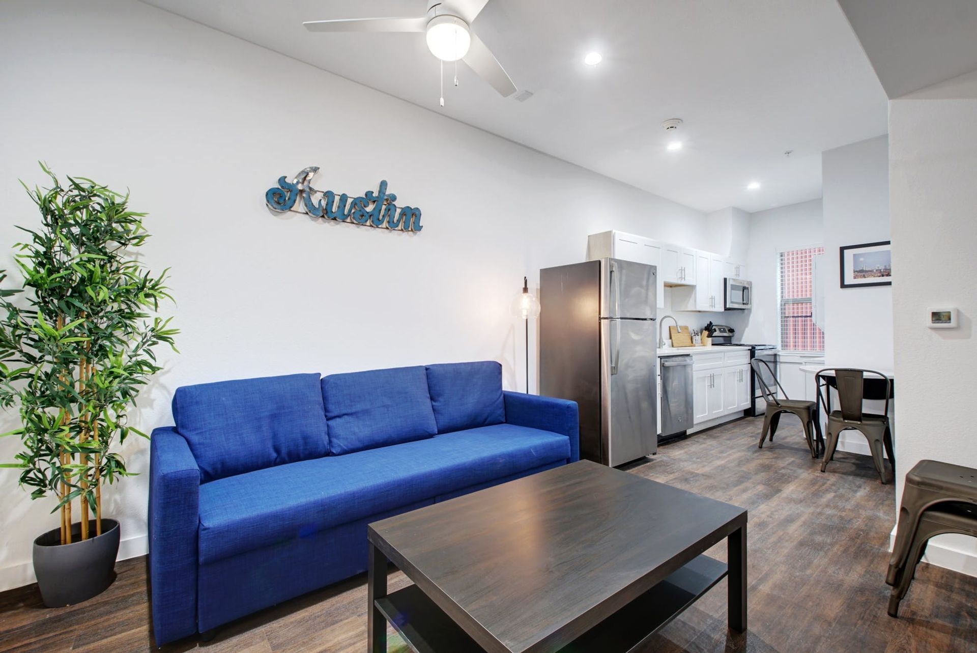 A living room with a blue couch and a coffee table