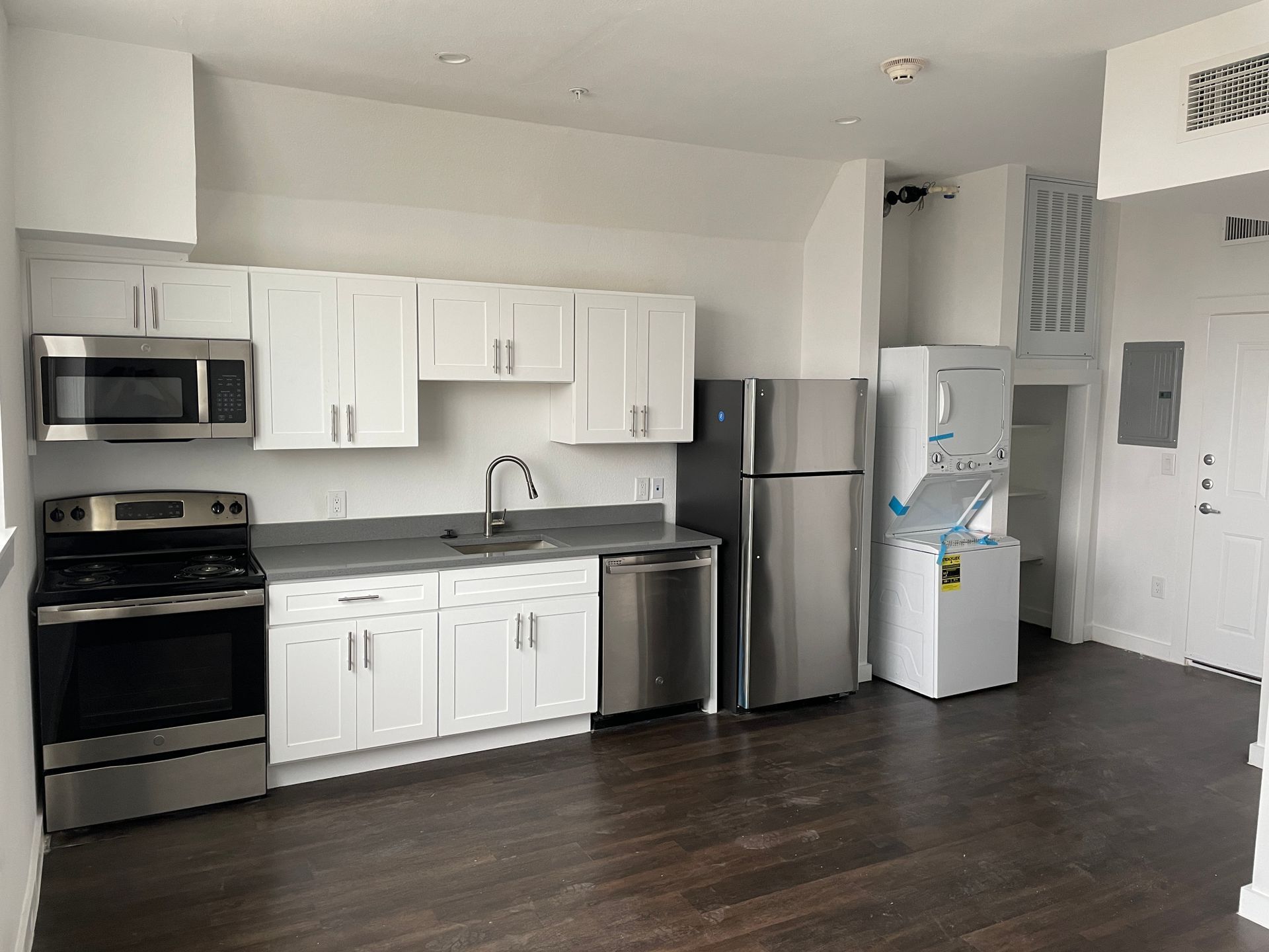 A kitchen with stainless steel appliances and white cabinets